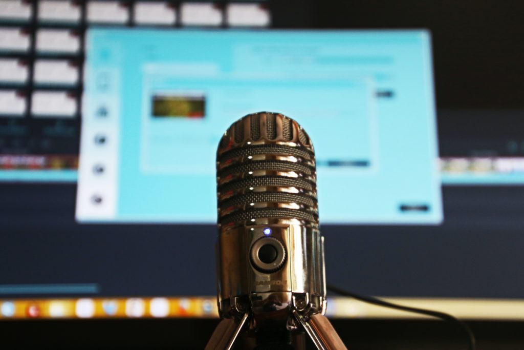 A microphone in front of a computer screen