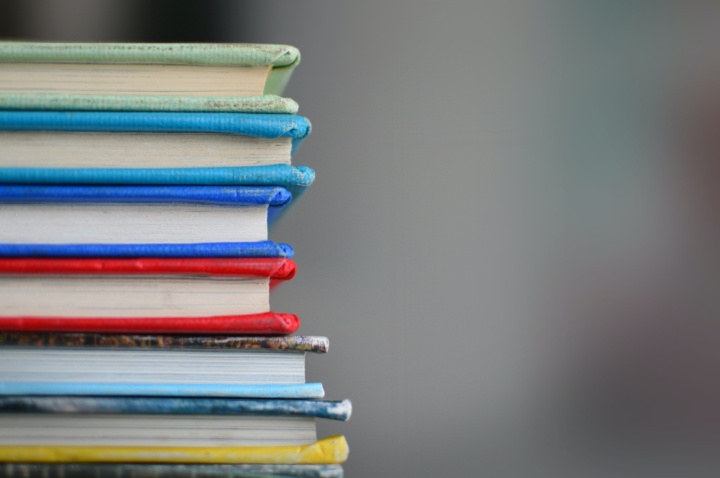 A stack of books with different colored covers.
