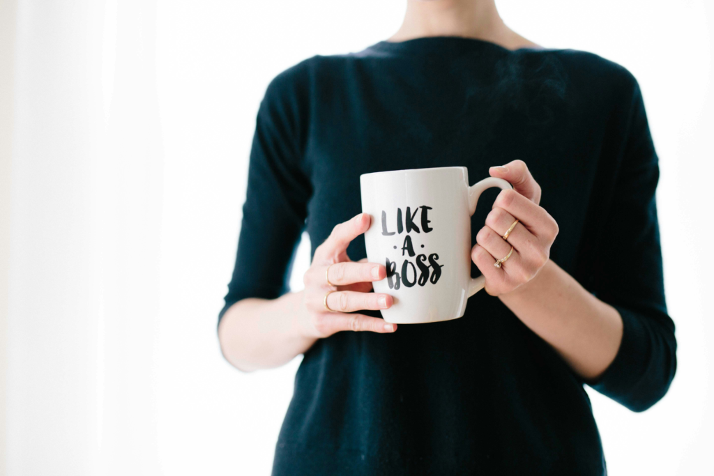 A lady with a coffee mug with the words "Like A Boss" printed on it