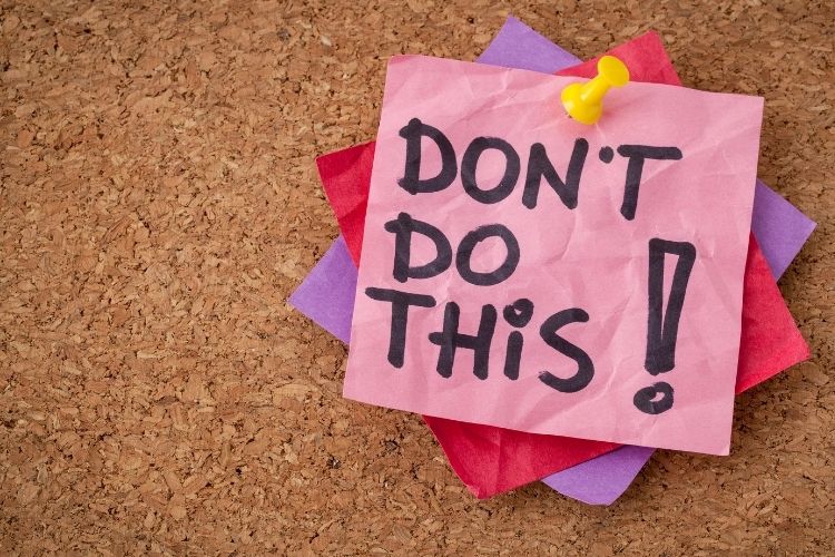 A cork board with a note pinned on it saying: "Don't Do This!"
