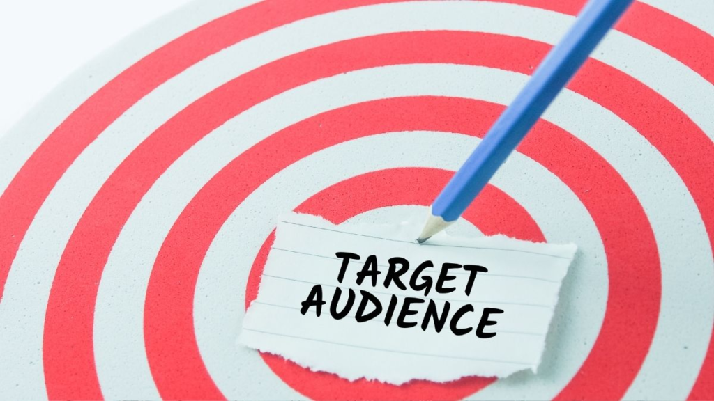 A red and white target board with a note in the middle with the words: "target audience".