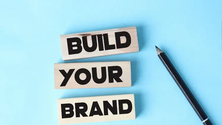 Building blocks with the words "Build Your Brand" and pencil.