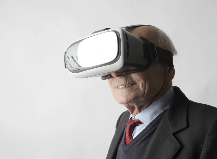 An older man wearing VR goggles.