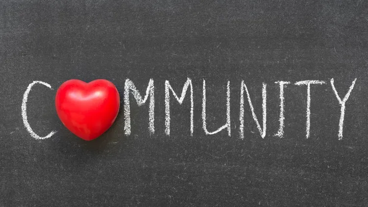 The word "community" on a chalkboard.