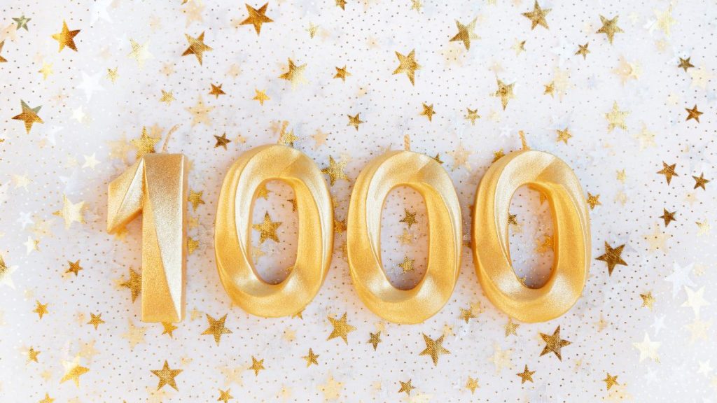 The number 1000 with little golden stars embellishing it.