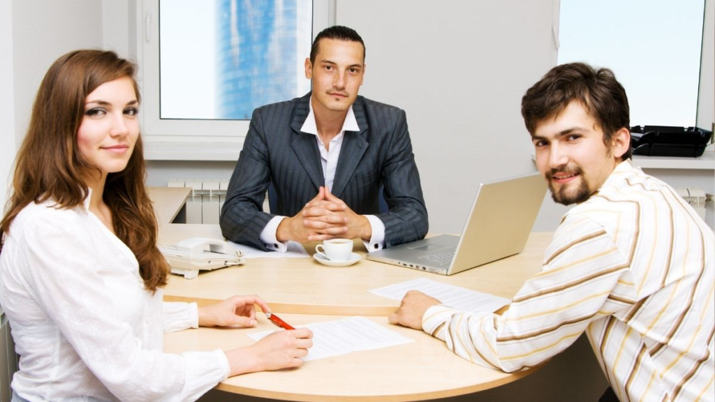 Three work colleagues sitting around a table.