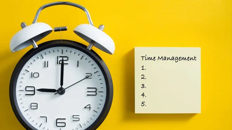 A clock and a notepad depicting time management.