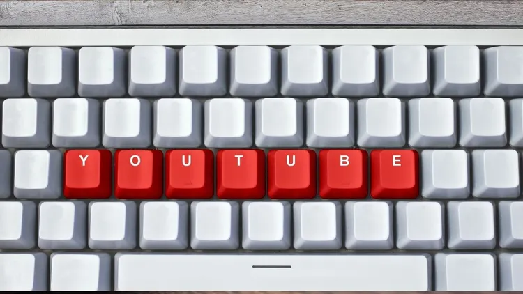 A keyboard with the words "YouTube" on the red keys.