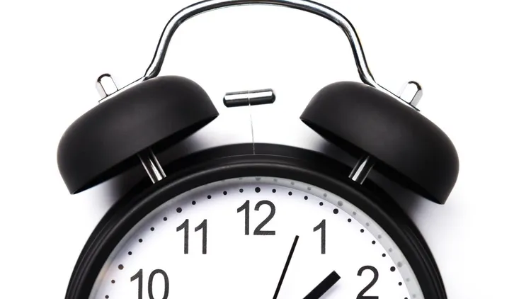 A black and white alarm clock.