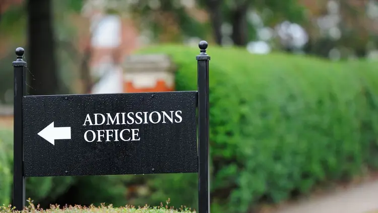 A sign directing to the Admissions Office of an university. 