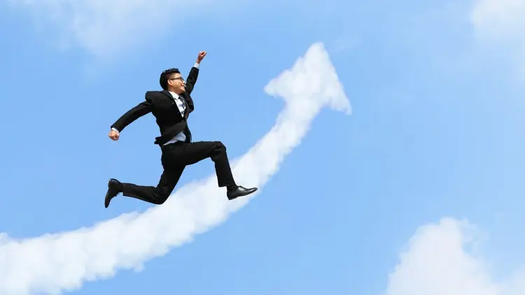 A man in a suit launching into the air.