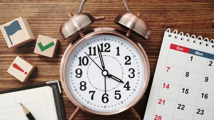 A clock and a calendar depicting time management.