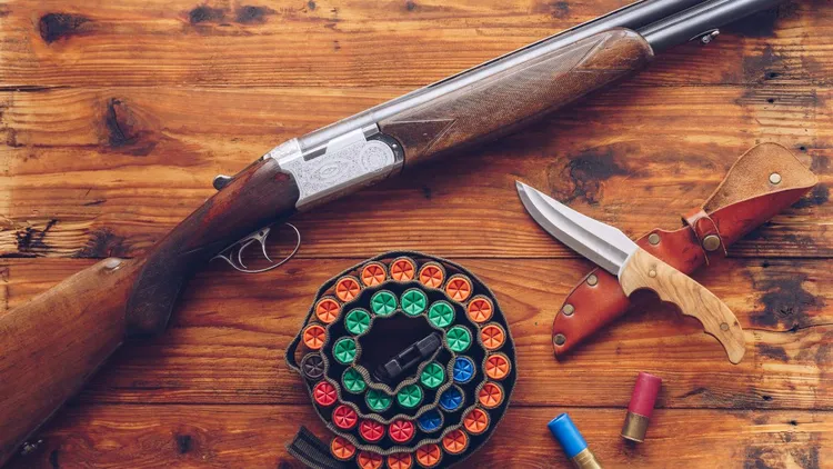 Hunting equipment: A rifle, bullets, and a knife.