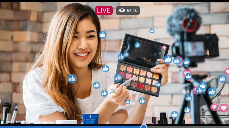 A woman making a video with the "like" icon depicting engagement. 