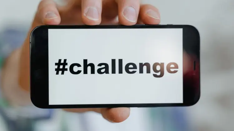 A cellphone with the word "#challenge" on the screen.