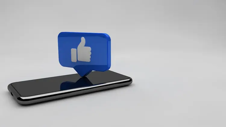 A cellphone with a Facebook thumbs up. 