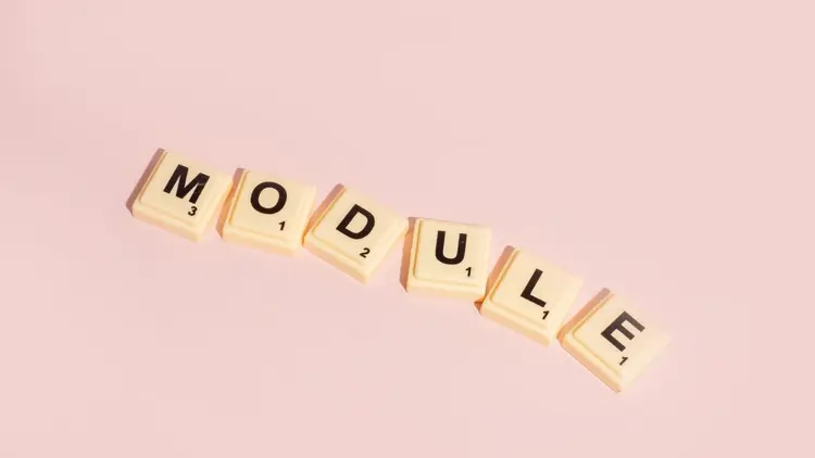 Scrabble letter tiles spelling out the word "Module"