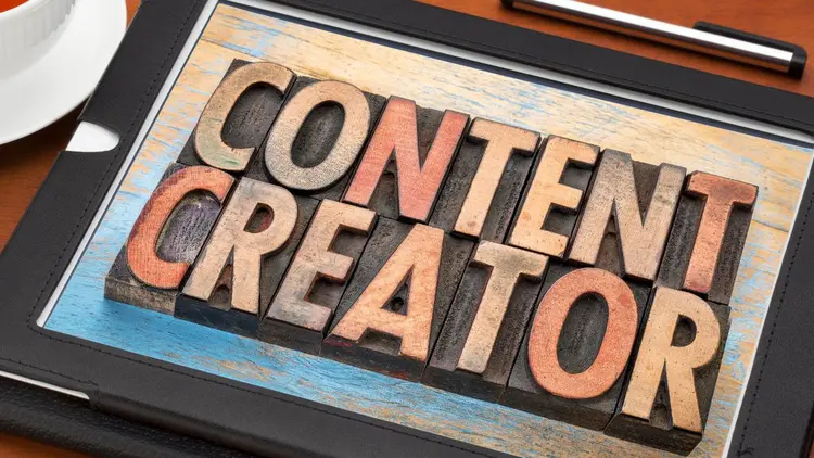 A tablet with the words "content creator" as a graphic. 
