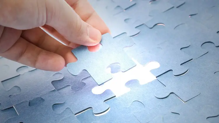An image of the last puzzle piece being added to a puzzle. 
