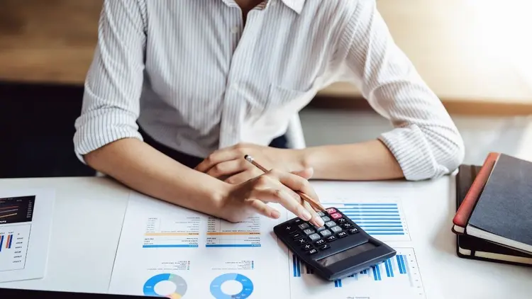 A woman calculating sales tax. 