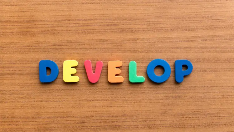 The word "develop" spelt out in children's alphabet letters. 