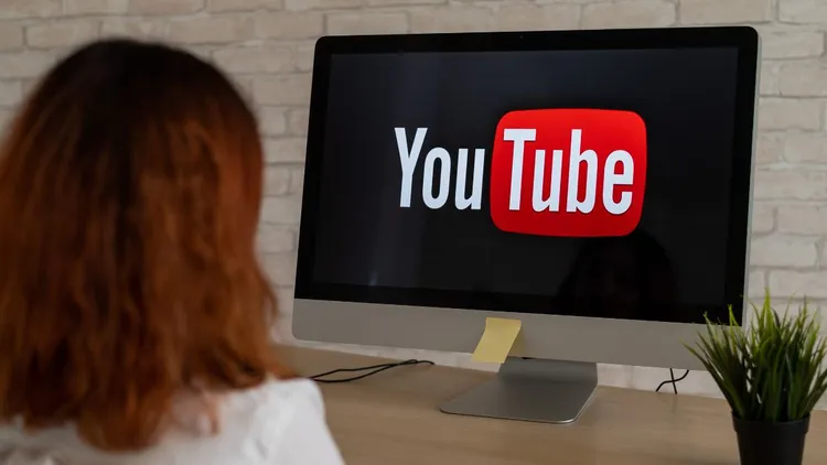 A woman looking at a YouTube channel.