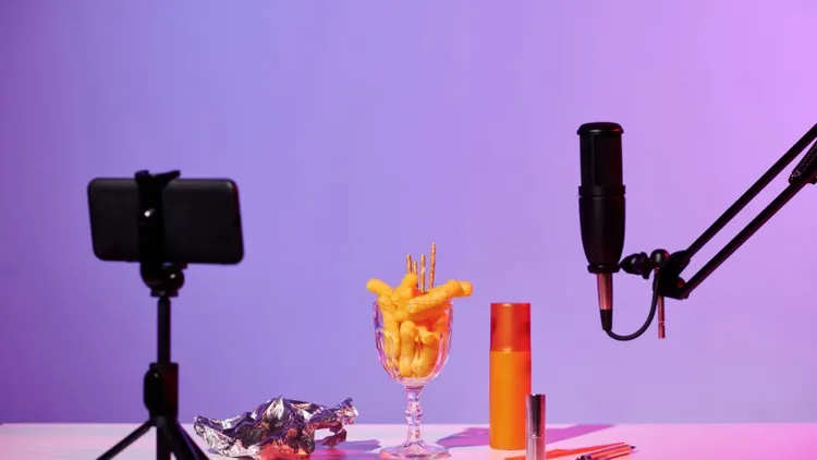 A cellphone and a microphone with various objects for ASMR. 