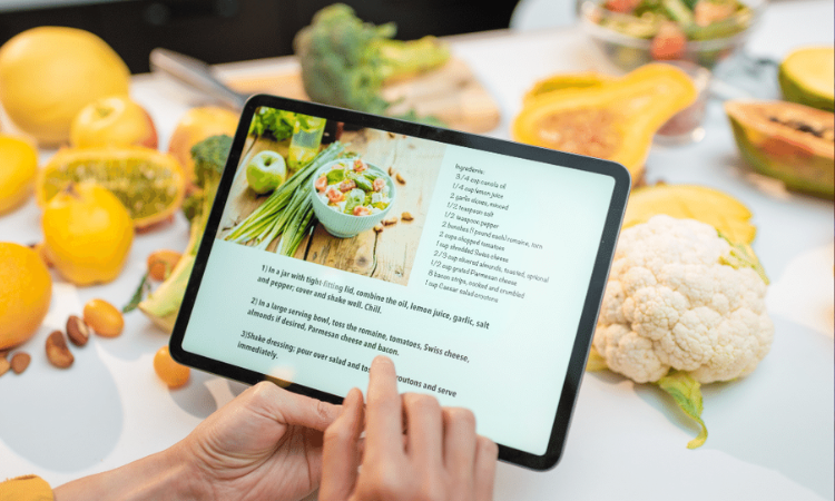 A person looking at a recipe from a digital tablet.