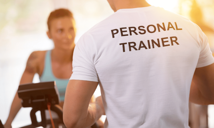 A personal fitness coaching working with a client.