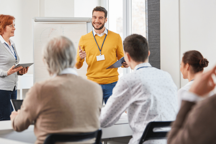 A man teaching a group of professionals.