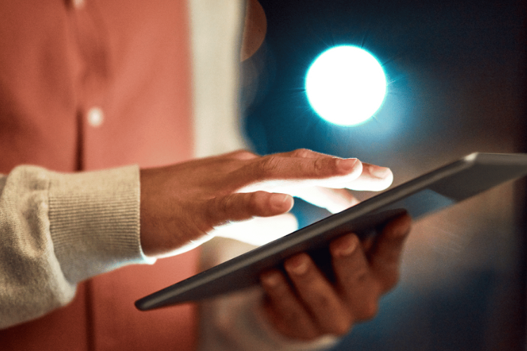 A person working on a digital tablet. 