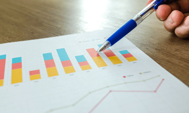 Pen and paper highlighting community metrics on a bar graph