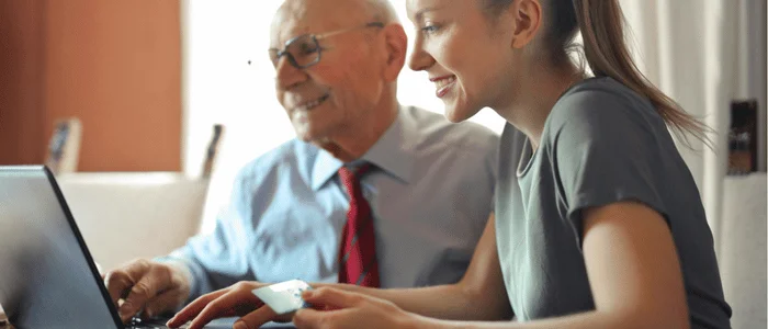 elderly man and young woman exploring community design concepts online